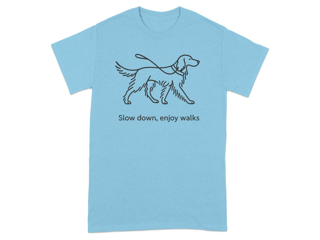 Light blue t-shirt with line drawing of a dog on a leash and text "Slow down, enjoy walks".