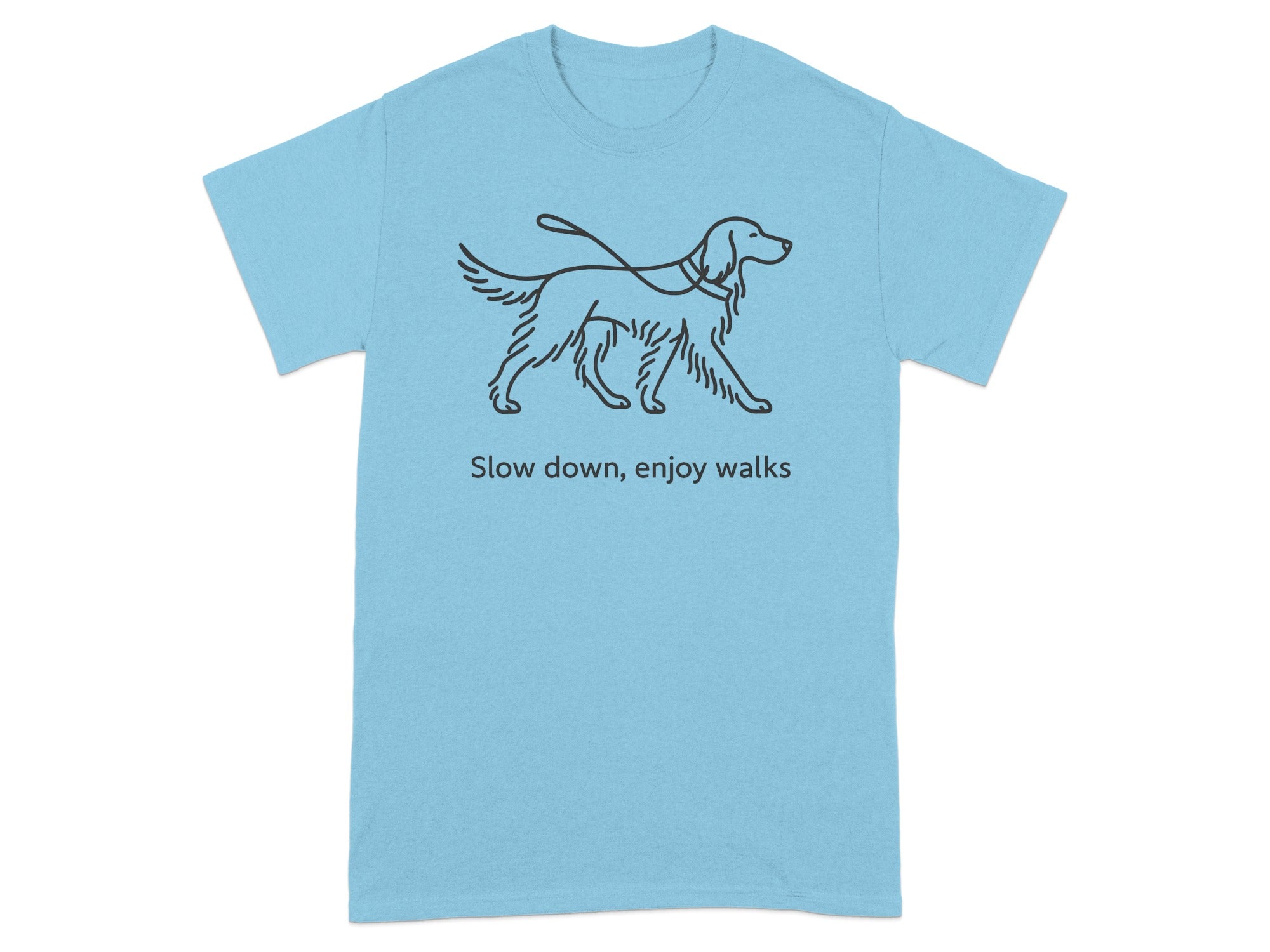 Light blue t-shirt with line drawing of a dog on a leash and text "Slow down, enjoy walks".