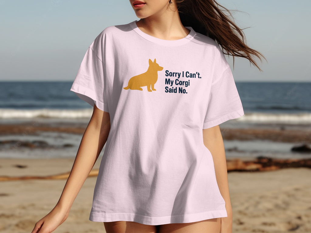 White t-shirt with a golden corgi silhouette and text "Sorry I Can't. My Corgi Said No."