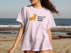 White t-shirt with a golden corgi silhouette and text "Sorry I Can't. My Corgi Said No."