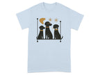 Three black dogs with collars, one wearing glasses, sit on a bar.