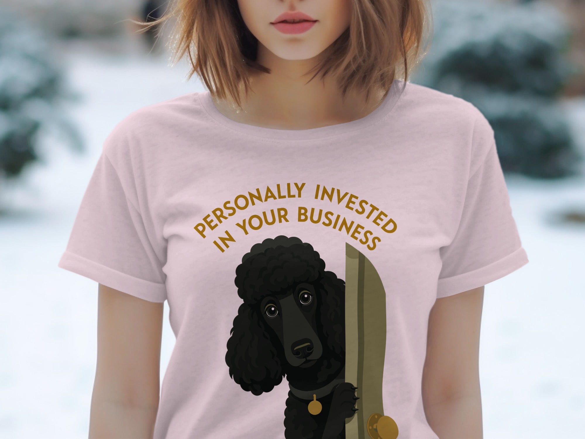 Pink t-shirt with a black poodle peeking out from behind a door, text reads "Personally Invested in Your Business".