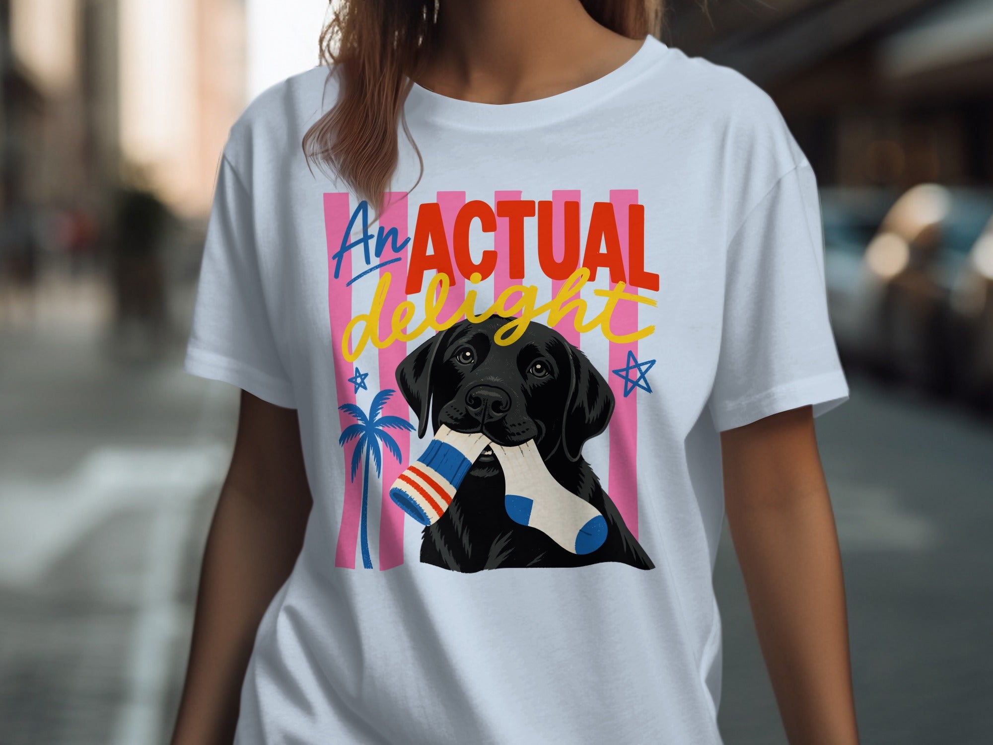 Black Labrador with sock in mouth on t-shirt with "An Actual Delight" text.