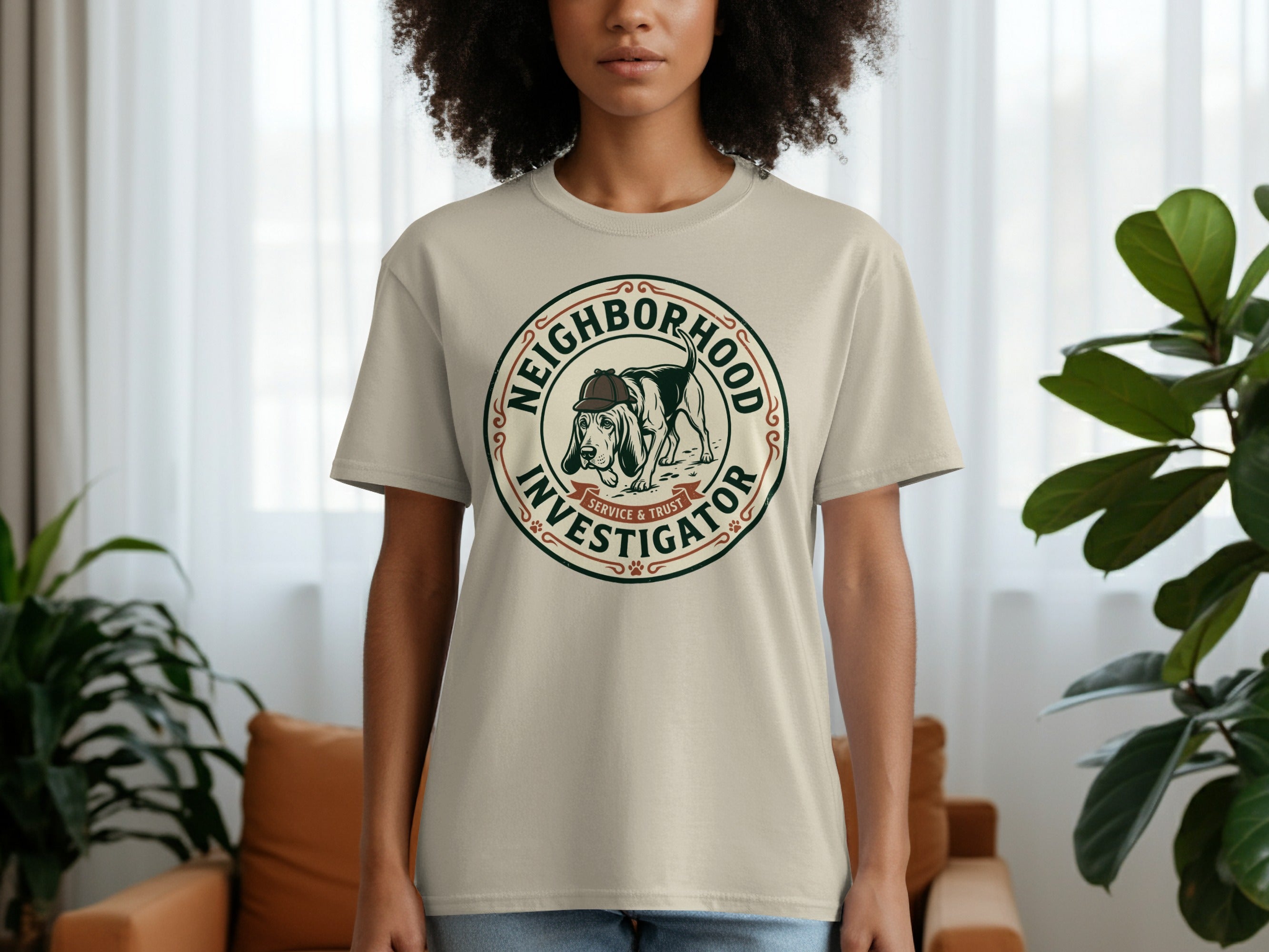 Beige t-shirt with "Neighborhood Investigator Service & Trust" emblem featuring a dog.