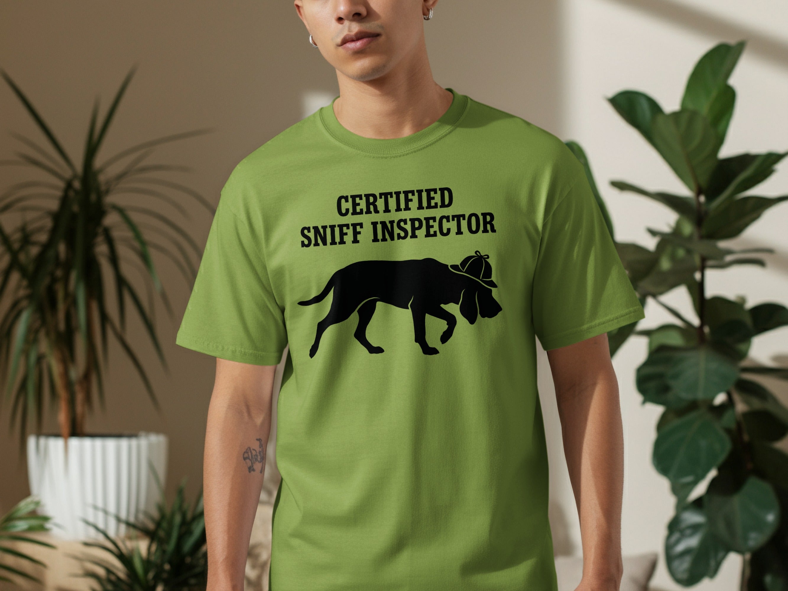 Green t-shirt with "CERTIFIED SNIFF INSPECTOR" and dog silhouette.