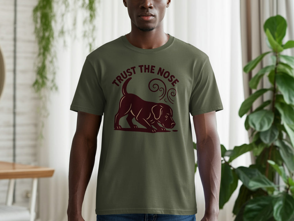 Green t-shirt with brown dog sniffing forward, text "TRUST THE NOSE".