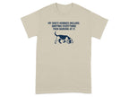 Tan t-shirt with dark blue text and dog graphic saying "MY DOG'S HOBBIES INCLUDE: SNIFFING EVERYTHING THEN BARKING AT IT."
