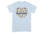 Light blue t-shirt with a heart made of beagles and paw prints and "BEAGLEHOLIC" text.