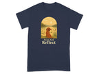 Navy t-shirt with a graphic of a dog by a lake and the words "Paws And Reflect".