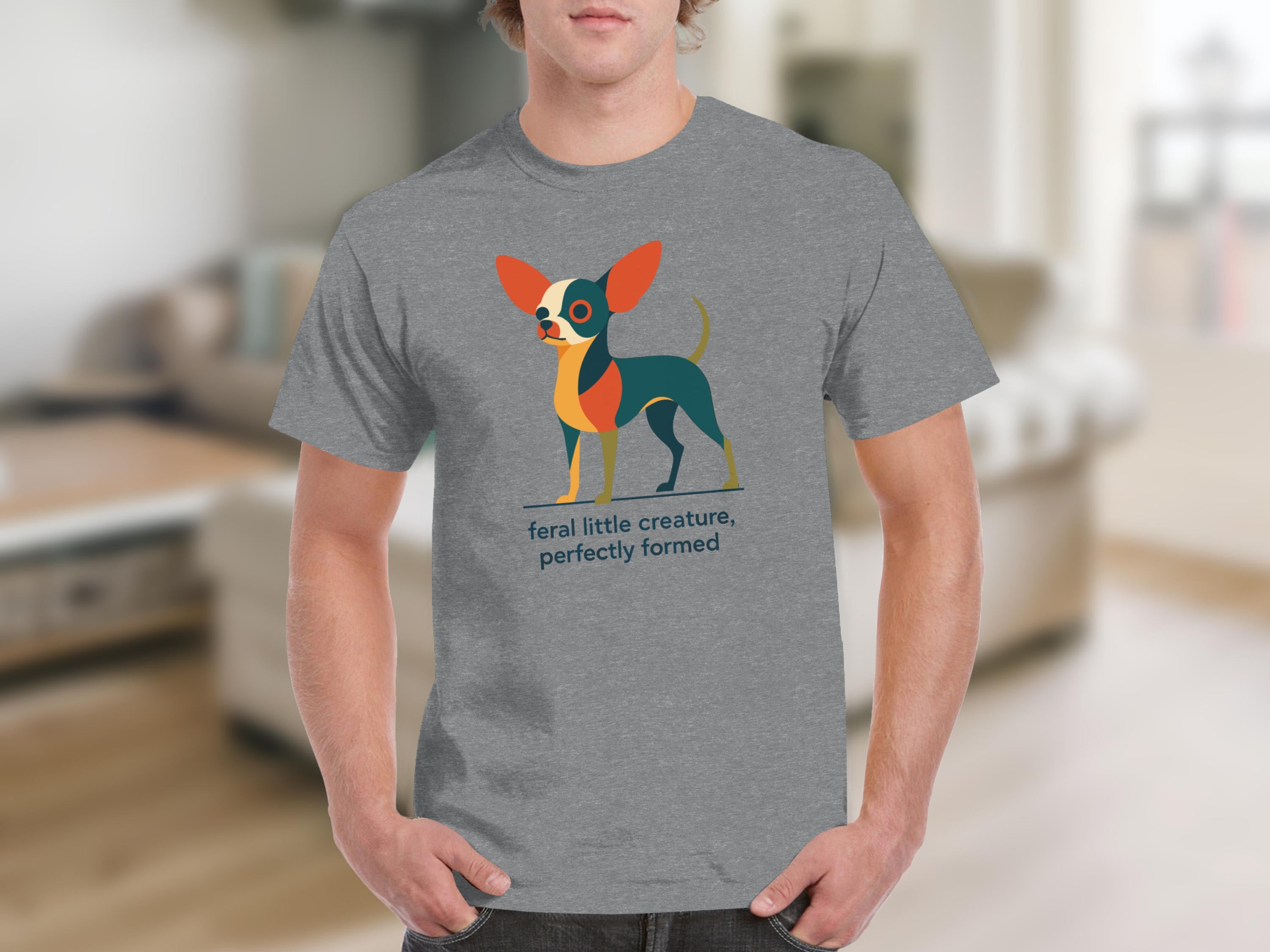 Grey t-shirt with a colorful stylized chihuahua and text that reads "feral little creature, perfectly formed".