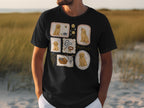 Black t-shirt with framed illustrations of golden retrievers and dog accessories.