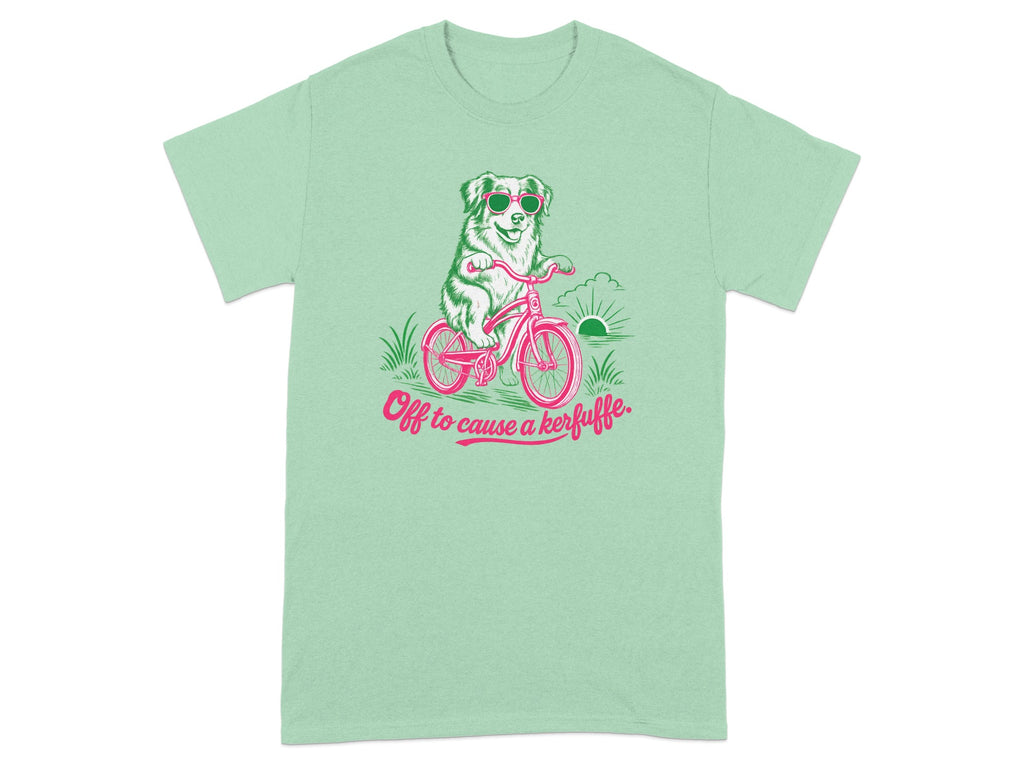 Green t-shirt with dog on bicycle wearing sunglasses and text "Off to cause a kerfuffle."