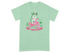 Green t-shirt with dog on bicycle wearing sunglasses and text "Off to cause a kerfuffle."
