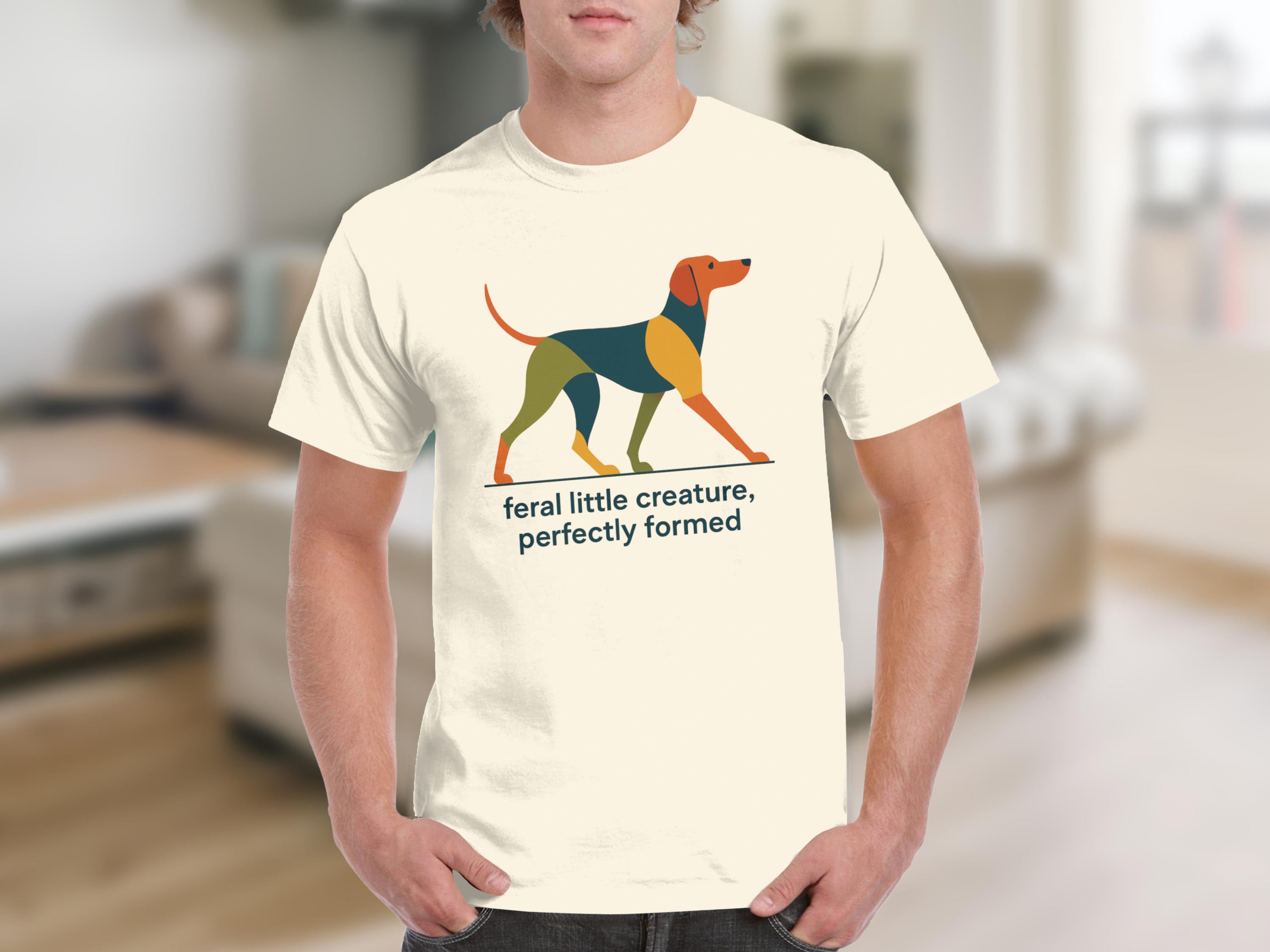 Cream t-shirt with geometric dog graphic and text "feral little creature, perfectly formed".