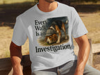 White t-shirt with beagle wearing hat and text "Every Walk Is an Investigation".
