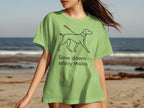Light green t-shirt with a dog and leash graphic and text "Slow down, enjoy walks".