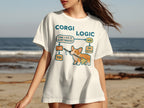Corgi wearing a bib with "Corgi Logic" flowchart on white t-shirt.
