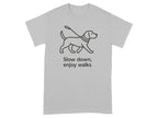 Gray t-shirt with line art of a dog on a leash and text "Slow down, enjoy walks."