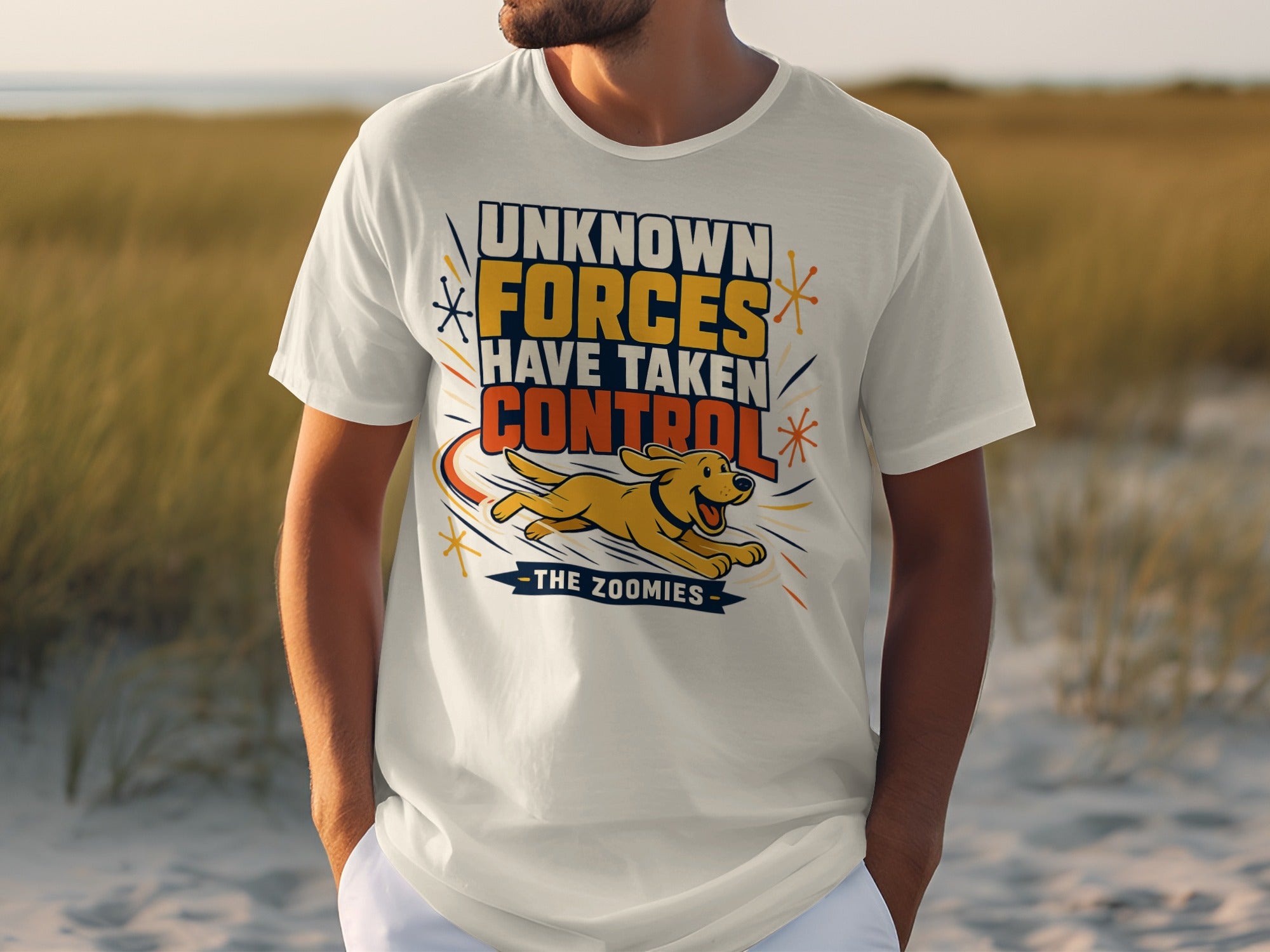 White t-shirt with "UNKNOWN FORCES HAVE TAKEN CONTROL THE ZOOMIES" and a running dog.