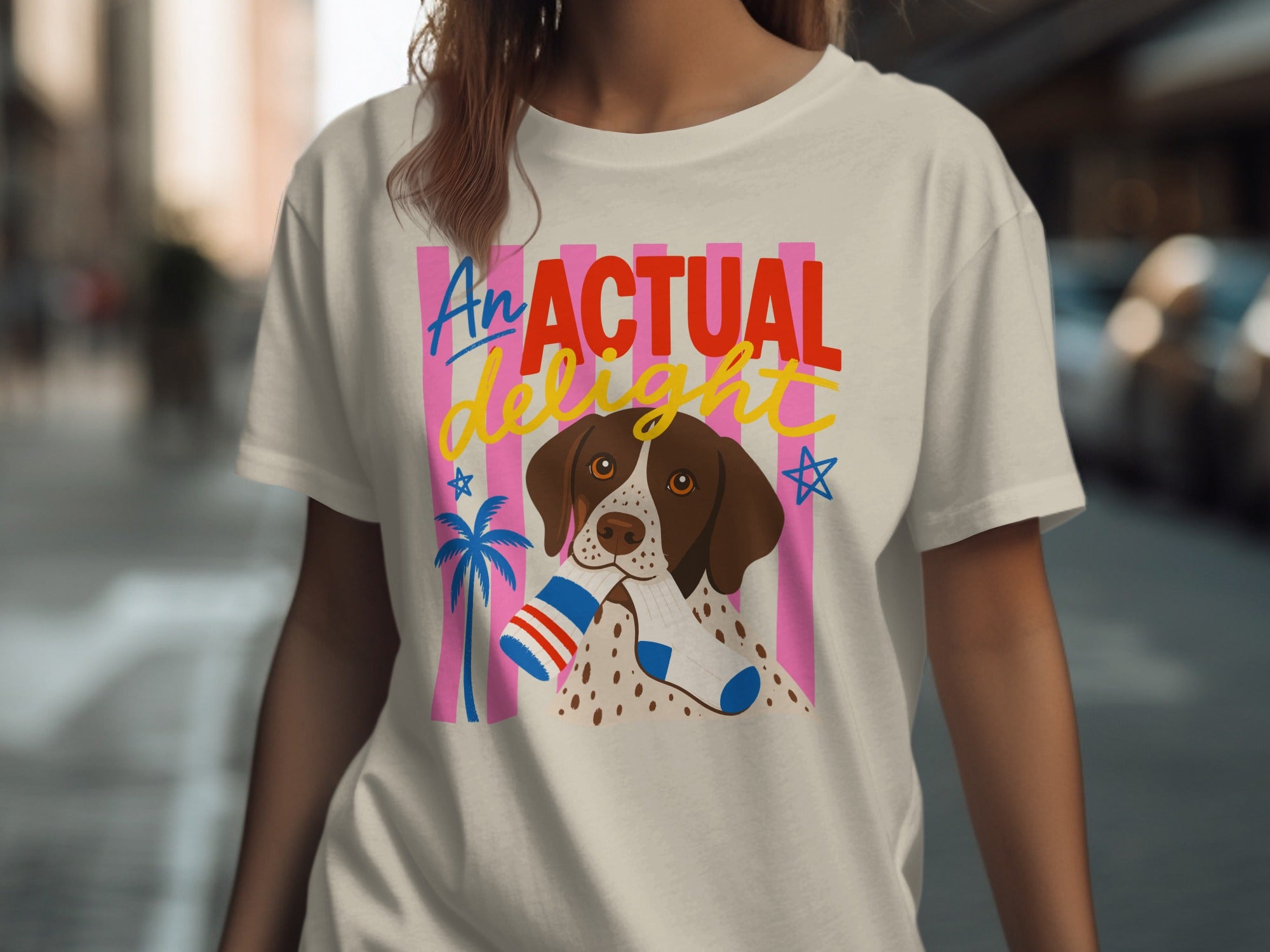 T-shirt featuring a dog wearing socks with "AN ACTUAL DELIGHT" text.