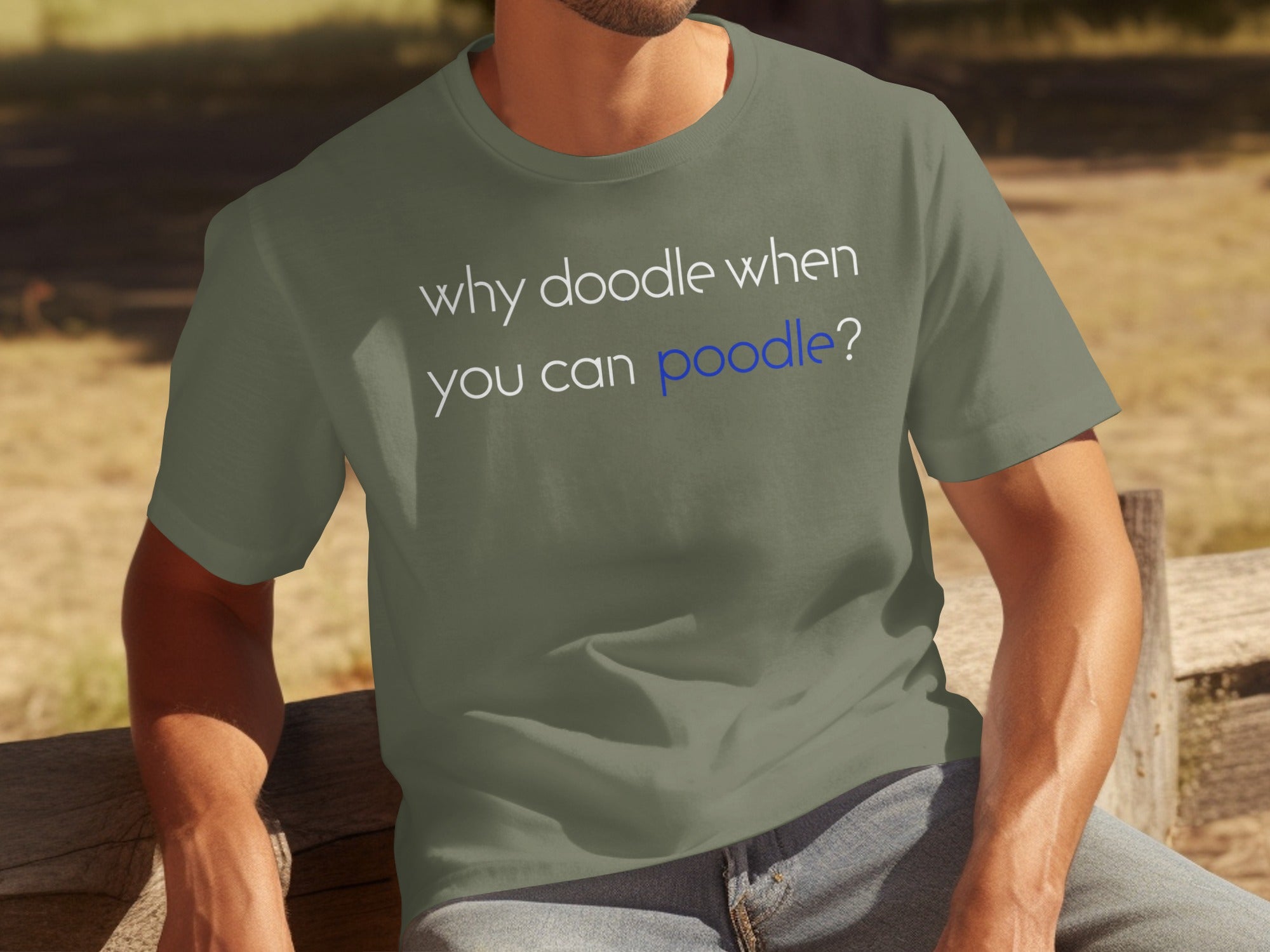 Olive green t-shirt with white and blue text "why doodle when you can poodle?".
