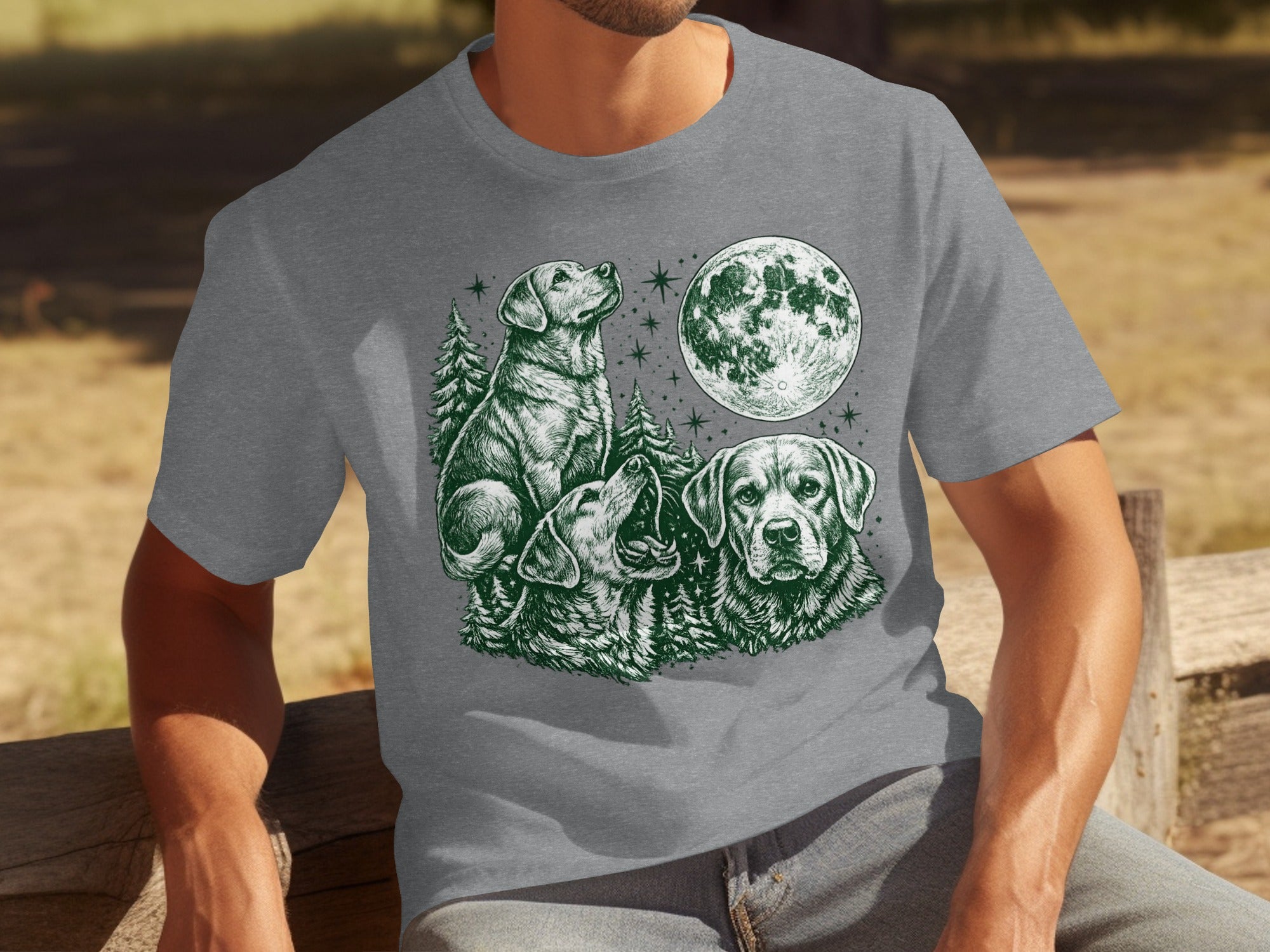 T-shirt with illustration of three dogs under a full moon with trees.