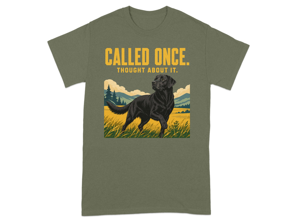 Black Labrador in grassy field on olive green t-shirt with text.