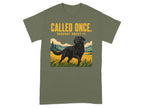 Black Labrador in grassy field on olive green t-shirt with text.