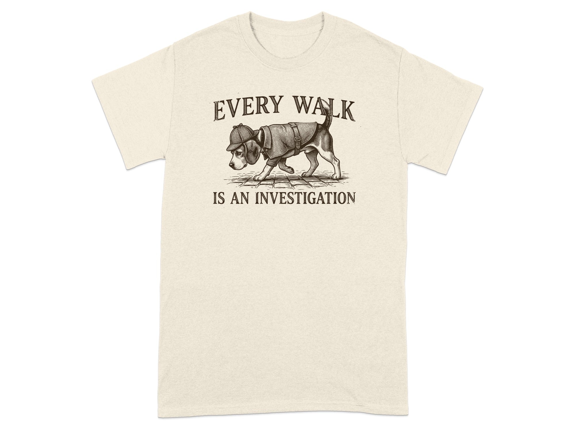 T-shirt with beige fabric, featuring a dog in a hat and coat, text reads "EVERY WALK IS AN INVESTIGATION".