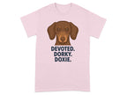 Pink t-shirt with a dachshund illustration and text "DEVOTED. DORKY. DOXIE."