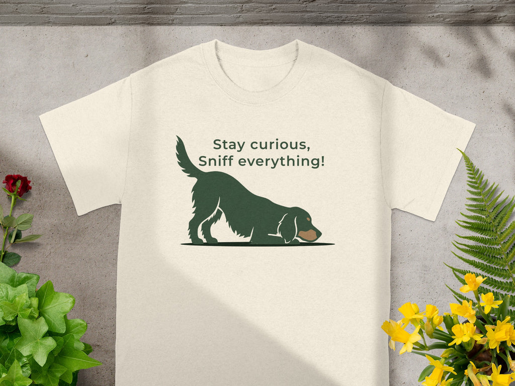 Cream t-shirt with dark green dog illustration and text "Stay curious, Sniff everything!".