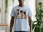 Light blue t-shirt with a graphic of three dogs sitting in a line.