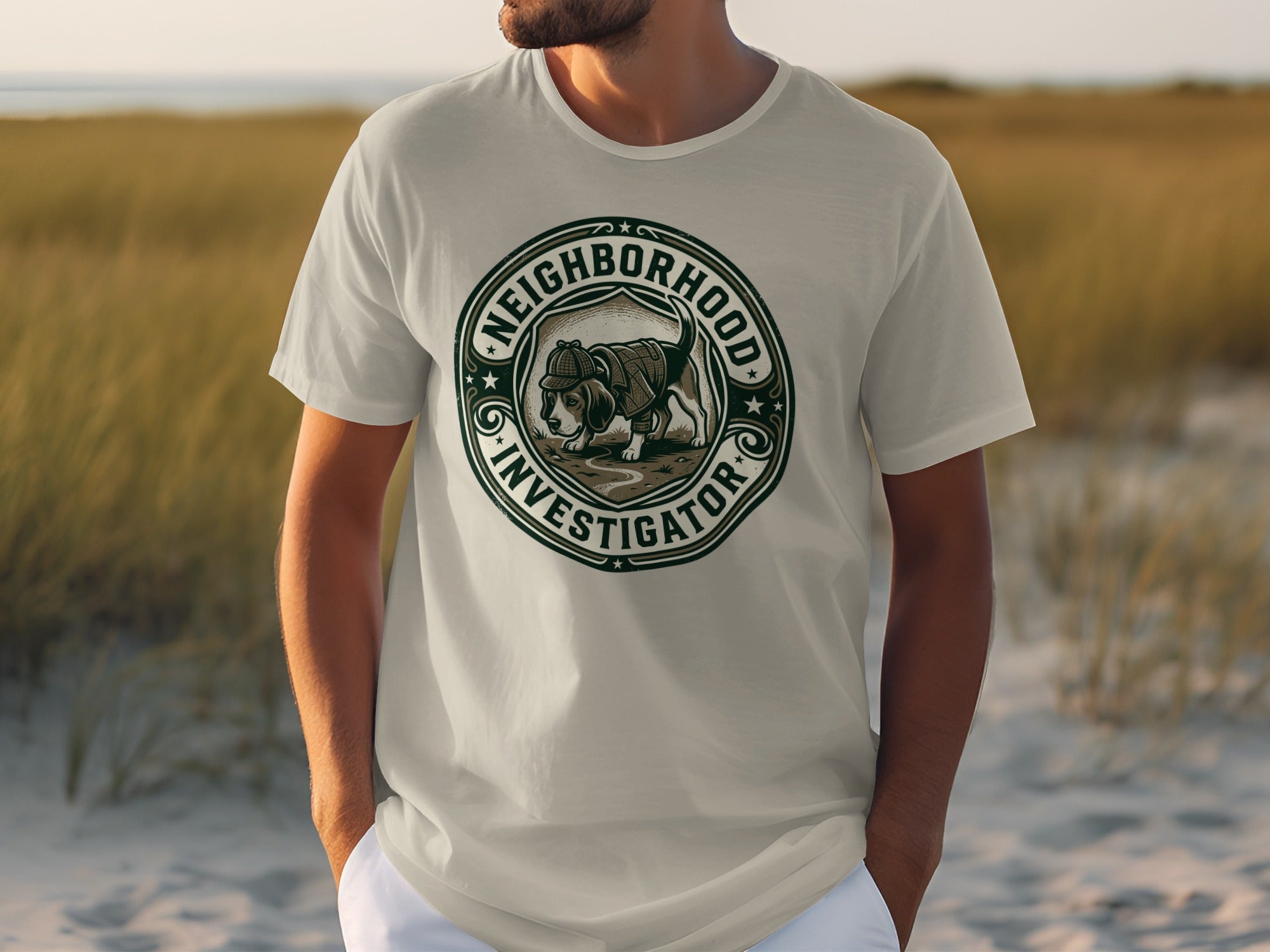 White t-shirt with "Neighborhood Investigator" circular logo featuring a dog wearing a detective hat.
