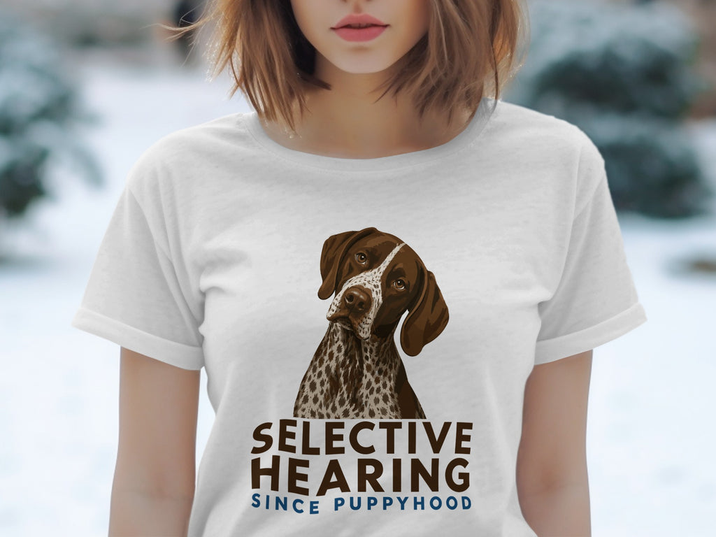 White t-shirt with a dog illustration and text "SELECTIVE HEARING SINCE PUPPYHOOD".