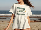 White t-shirt with "STAY WILD CHASE THE LURE" and dog silhouette.