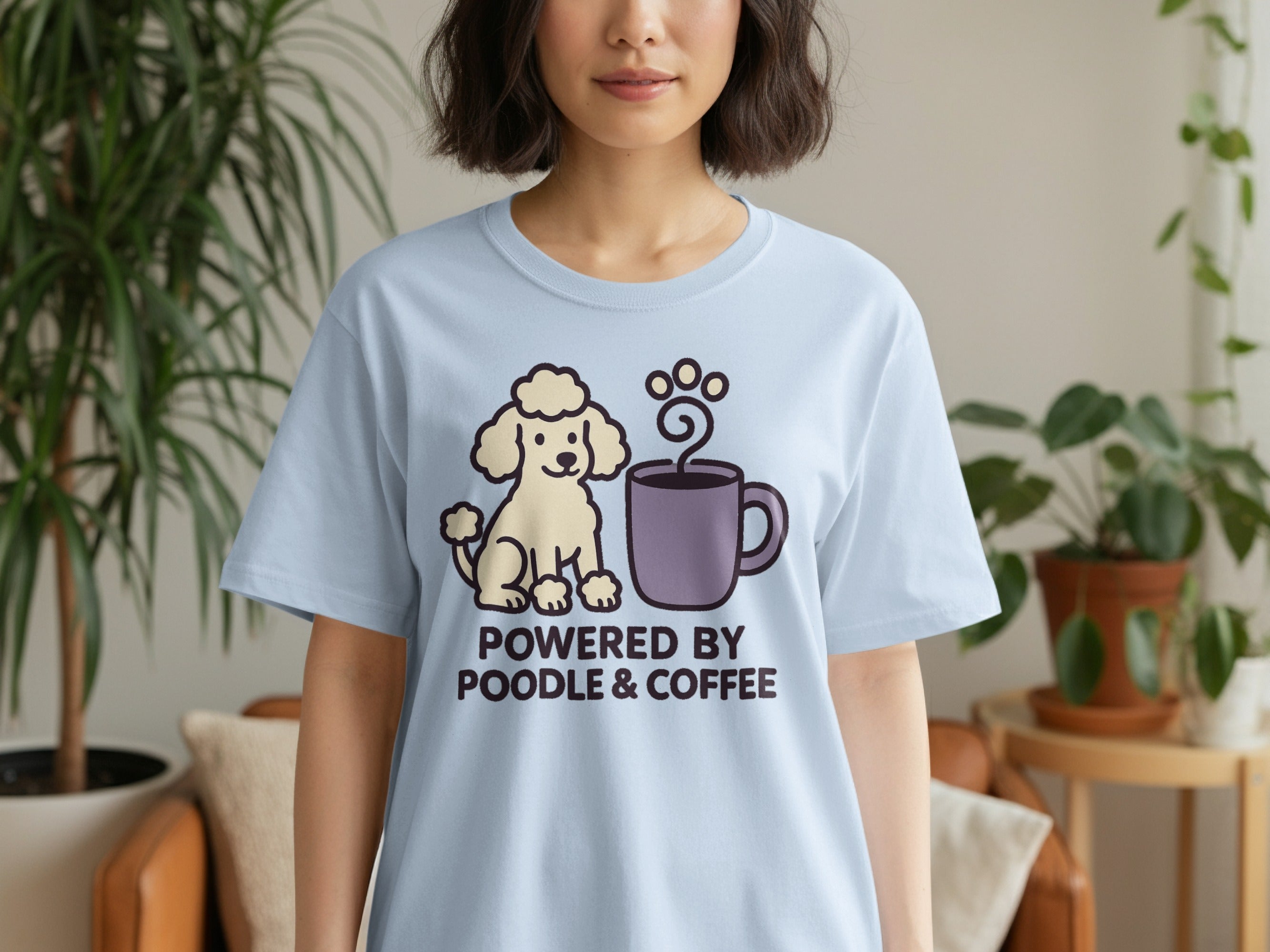 Light blue t-shirt with a cartoon poodle and coffee mug graphic, reading "Powered by Poodle & Coffee".