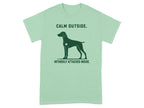 Green t-shirt with a dog silhouette and text "CALM OUTSIDE. INTENSELY ATTACHED INSIDE."