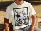 Cream t-shirt with a black and white woodcut-style print of a basset hound lying on its back.