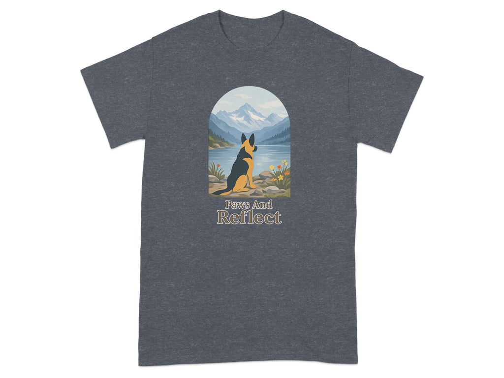 German Shepherd sits by a lake with mountains, with text "Paws And Reflect".