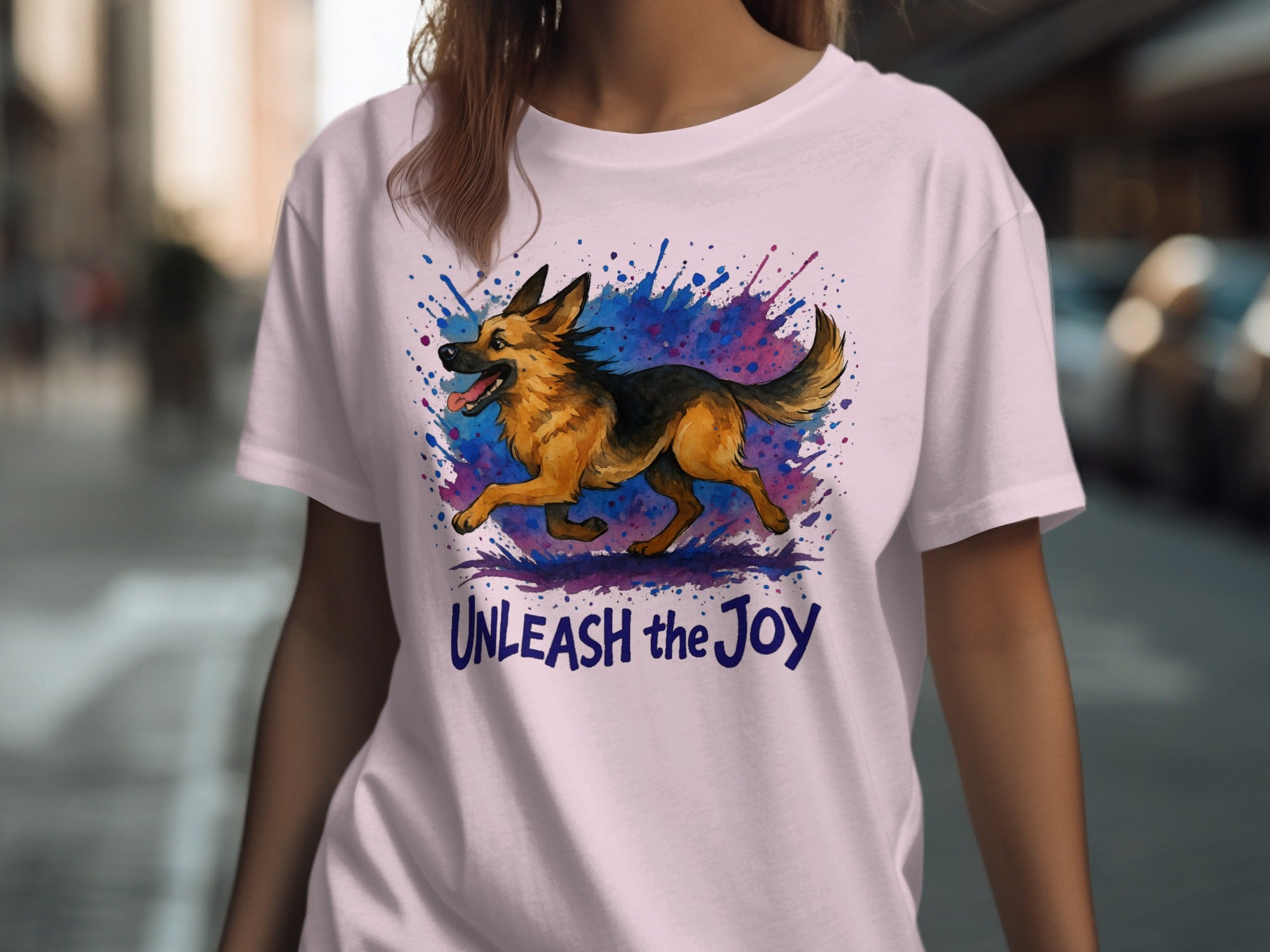 Pink t-shirt with a German Shepherd in watercolor splash and "Unleash the Joy" text.