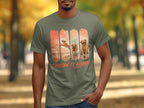 T-shirt featuring golden retrievers playing fetch on beaches, with text "THROW IT AGAIN!".