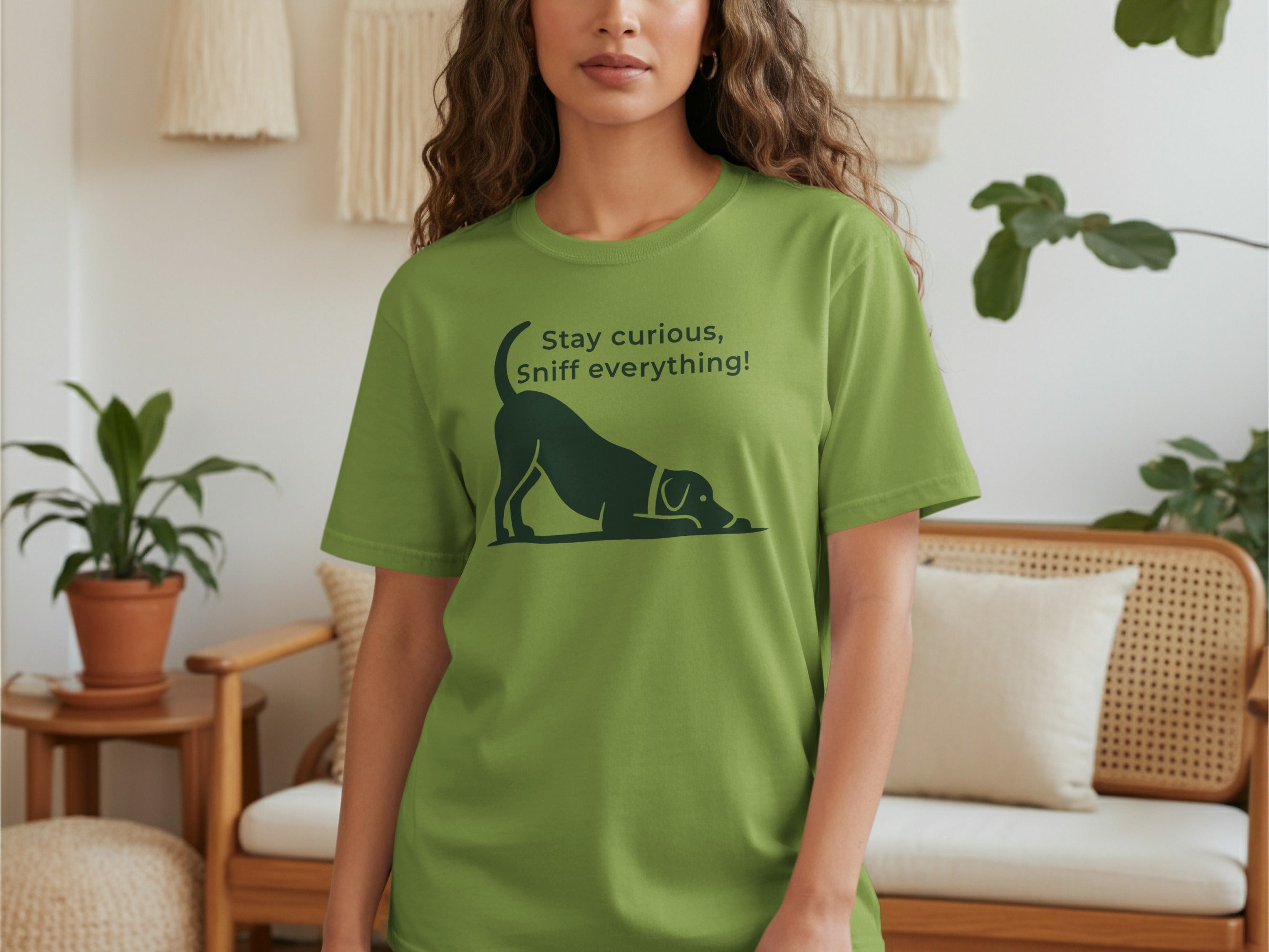 Green t-shirt with a dog silhouette and "Stay curious, Sniff everything!" text.