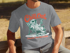 T-shirt graphic with a dog in a lounge chair holding a drink and wearing sunglasses.