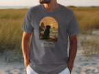 Gray t-shirt with black dog at sunset graphic and text "Paws And Reflect."