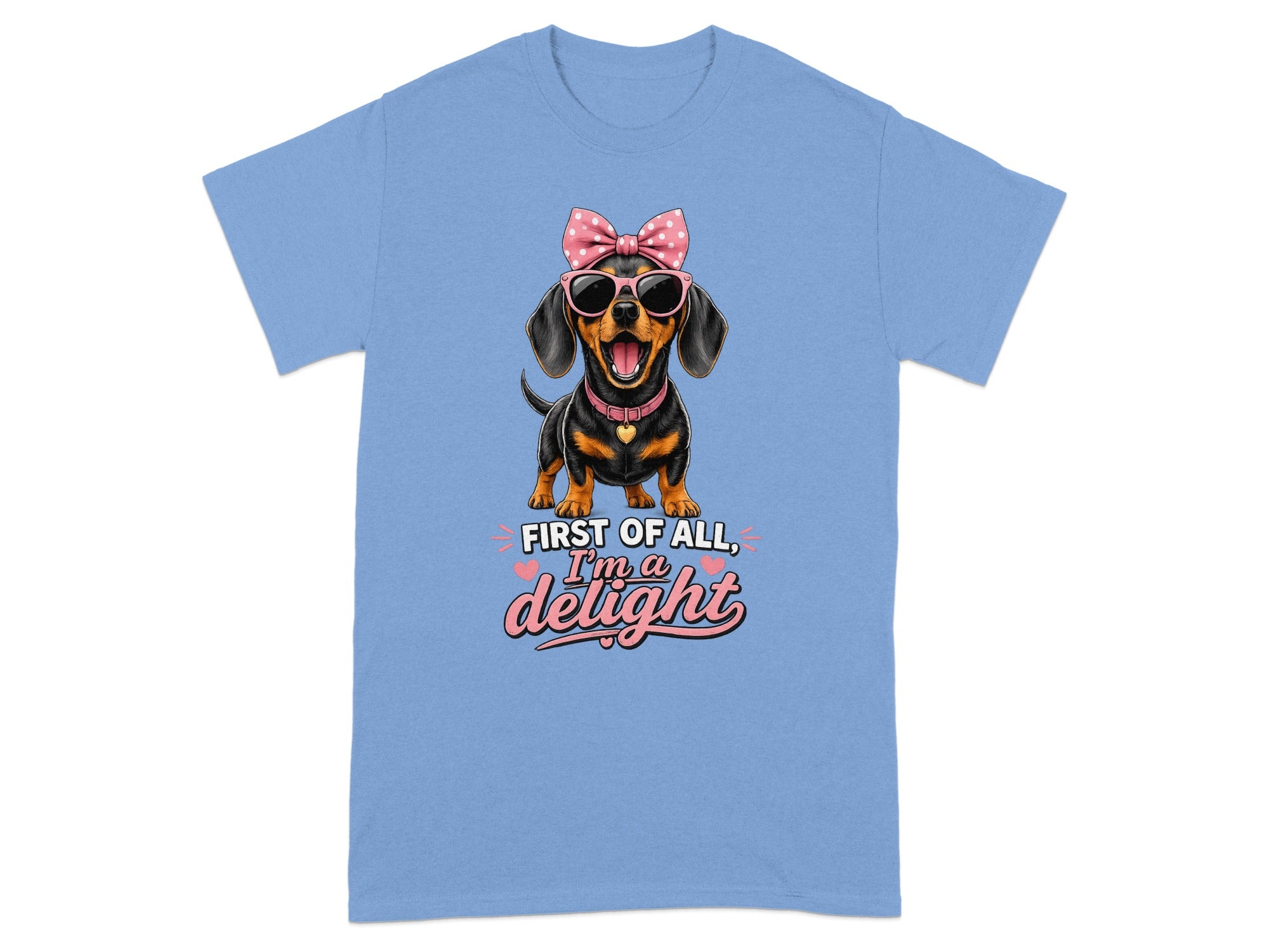 Blue t-shirt with a dachshund wearing sunglasses and a pink bow, text reads "First of all, I'm a delight".
