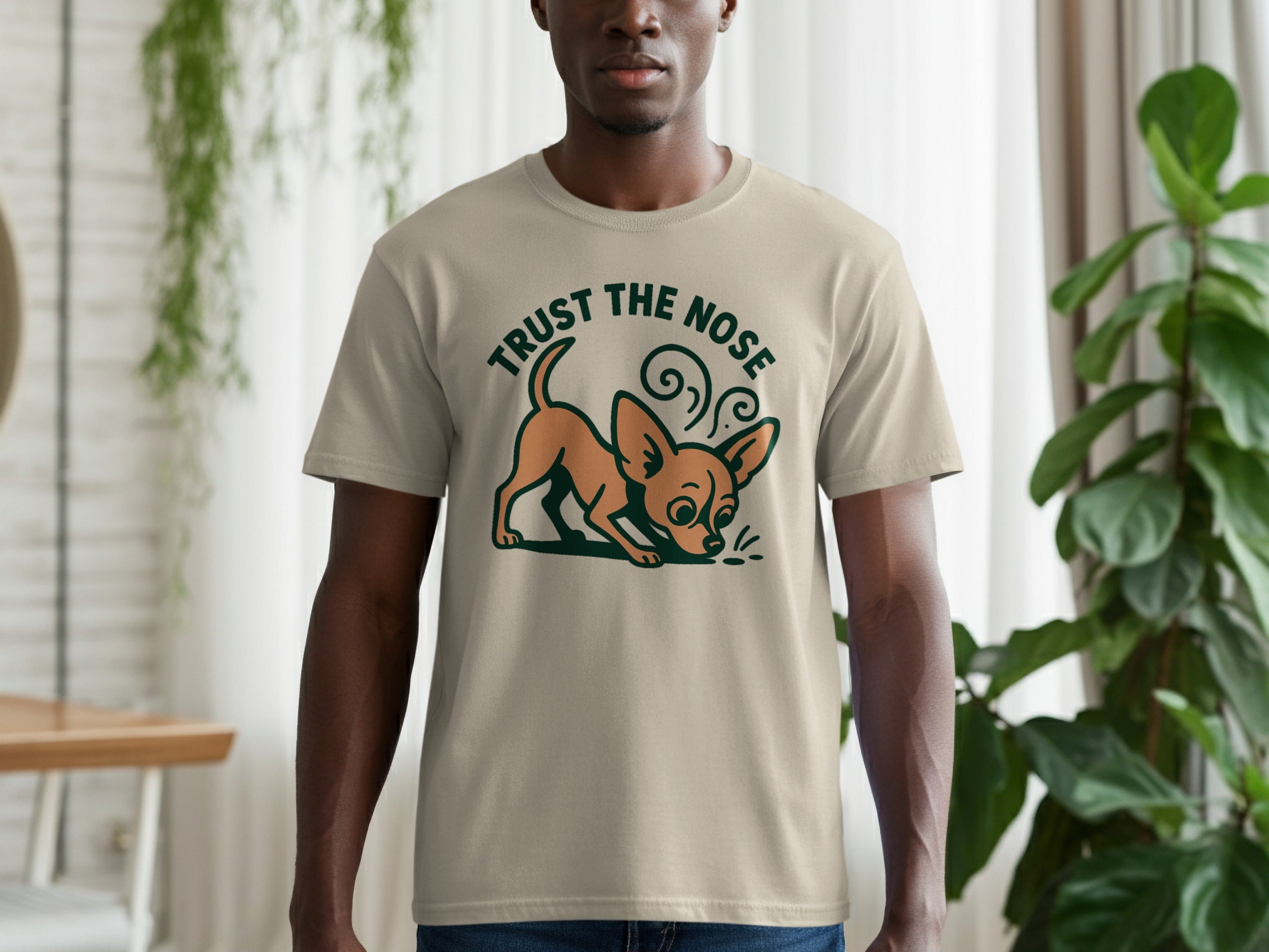Beige t-shirt with a cartoon chihuahua and text that says "TRUST THE NOSE".