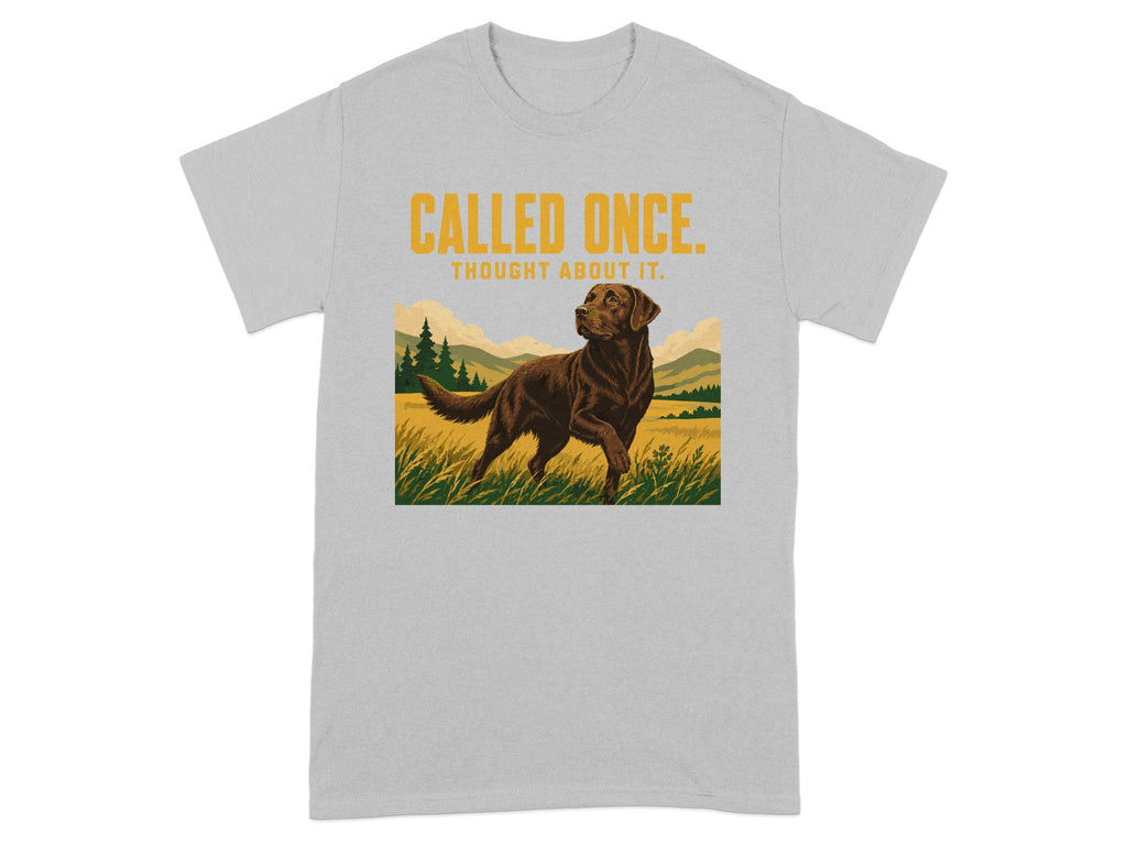 Brown dog in field with "CALLED ONCE. THOUGHT ABOUT IT." text on t-shirt.