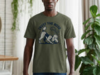 Olive green t-shirt with a poodle graphic and text "TRUST THE NOSE".