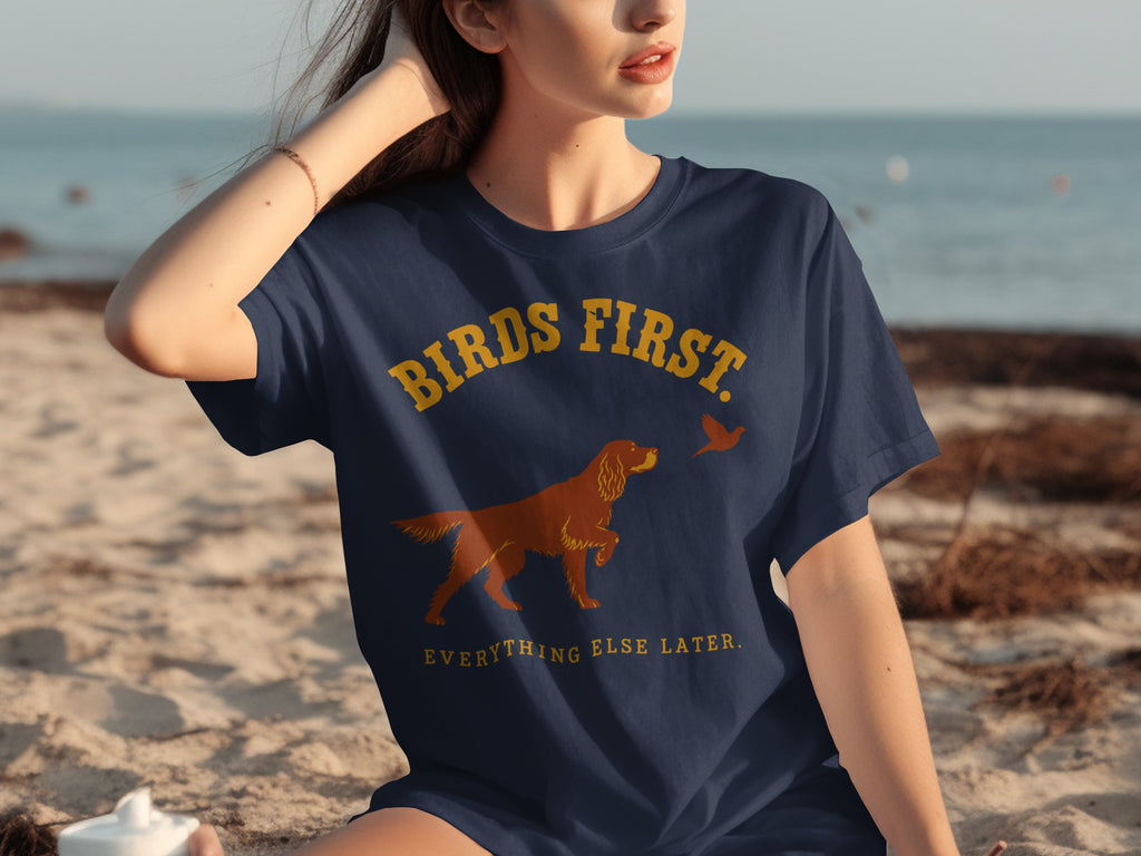Navy t-shirt with "Birds First. Everything Else Later." text and dog silhouette.