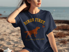 Navy t-shirt with "Birds First. Everything Else Later." text and dog silhouette.
